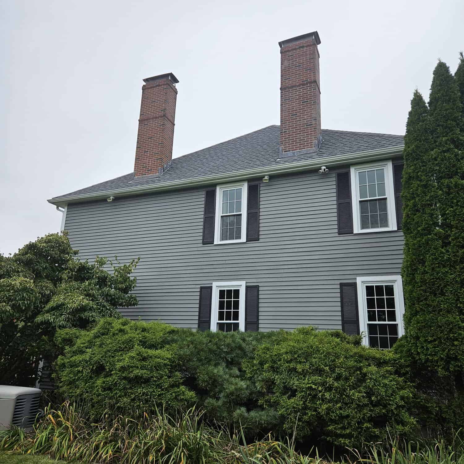 House siding in gray with white window trim